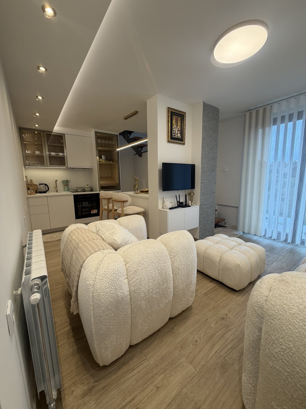 Modern apartment living room with kitchen and seating